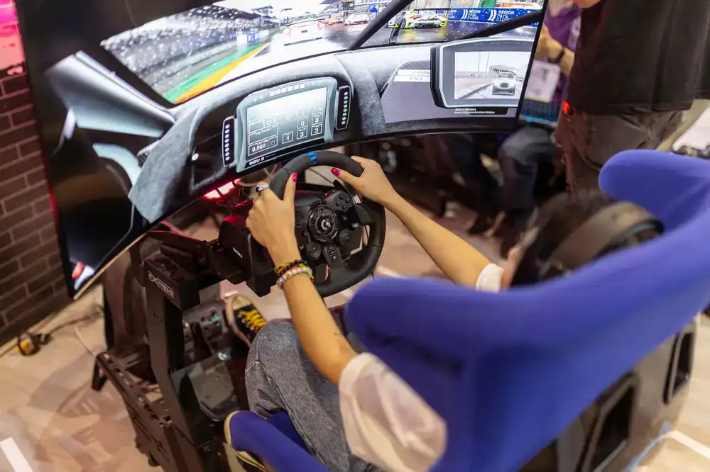Sim racing driver gripping steering wheel in a professional simulator cockpit